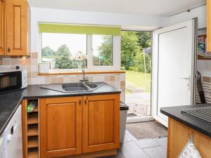 uma cozinha com um lavatório e uma janela em The Cottage em Great Driffield