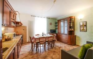 a kitchen with a table and chairs in a room at Amazing Apartment In Mezzana With Wifi And 2 Bedrooms in Mezzana