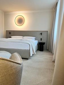 a hotel room with two beds and a chair at ADELANTE Boutique Hotel in Berlin
