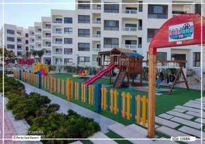 a playground in front of a large building at Porto said Resort - Luxury Studio Seaview 43 m2 شالية إستوديو فندقي فاخر فيو البحر in `Ezbet Shalabi el-Rûdi