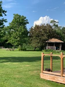 a park with a gazebo and a wooden fence at Cairns Motel in Summerside