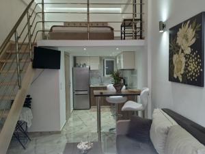 a kitchen and a living room with a loft at M&S Corfu Centre Apartment in Ágios Rókkos