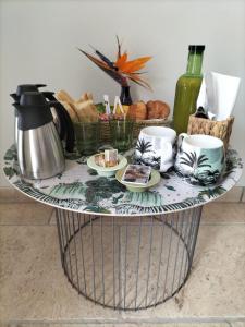 a coffee table with cups and bread on it at Chambre d'hôtes Chante Cigale in La Ciotat