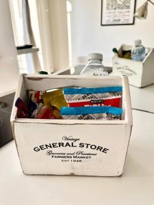 a box of general store items sitting on a counter at Belgrave Studio Apartments, Westminster London in London
