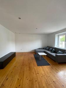 a living room with a couch and a table at Modernes Haus in Parndorf in Parndorf