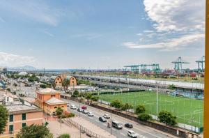 una vista aerea di una città con campo da calcio di casa vacanza Laura a Genova