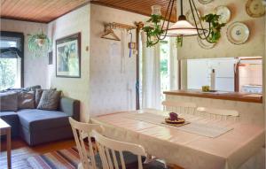 a kitchen and living room with a table and a couch at Pet Friendly Home In Backaryd With House A Panoramic View in Backaryd
