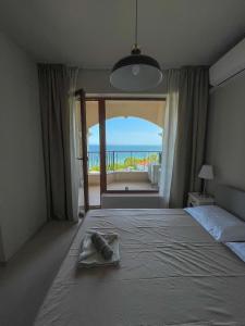 a bedroom with a bed with a view of the ocean at Cabacum Beach Residence AP.19 in Varna City