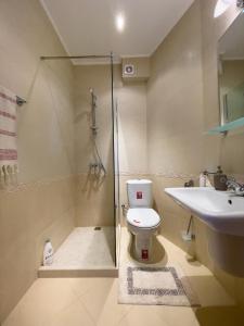 a bathroom with a shower and a toilet and a sink at Cabacum Beach Residence AP.19 in Varna City