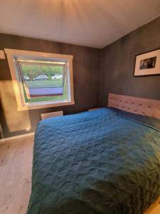 a bedroom with a large bed and a window at Private room in Oslo in Oslo