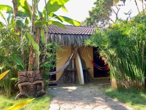 a small house with a statue in front of it at La Buena Vida Hotel in Ayampe