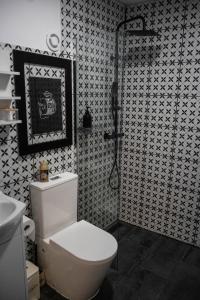 a black and white bathroom with a toilet and a shower at Porta Green in Budapest