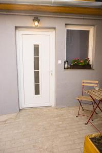a white door with a table and a chair at Porta Green in Budapest