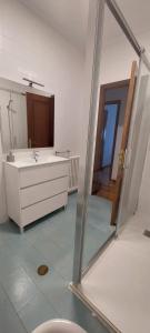 a bathroom with a sink and a mirror at Piso Ribeira Sacra in Monforte de Lemos +8 photos