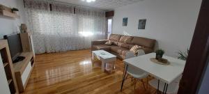 a living room with a couch and a table at Piso Ribeira Sacra in Monforte de Lemos