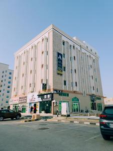 um grande edifício com um carro estacionado em frente em أجاويد Ajaweed em Salalah