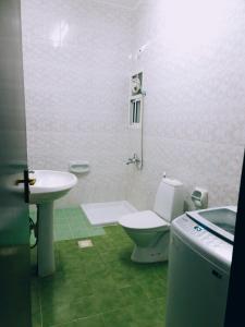 a bathroom with a toilet and a sink at أجاويد Ajaweed in Salalah