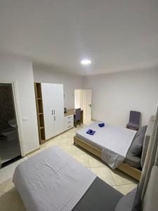 a bedroom with a bed and a desk and chairs at Vila Gashi in Durrës