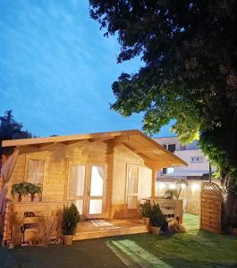 a small wooden house with a porch at Dreamholia in Jastarnia