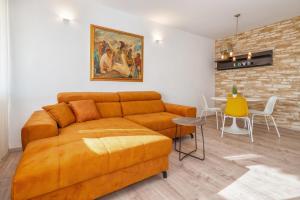 a living room with a couch and a table at Split Serenity/ Suite with Sea View Balcony in Split