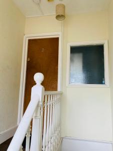 a staircase in a house with a window and a door at Contemporary 2nd floor shared flat near Bedford train station in Bedford