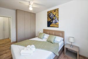 a bedroom with a large bed with towels on it at Split Serenity/ Suite with Sea View Balcony in Split