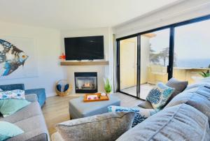 a living room with a couch and a fireplace at Royal Villa - Ocean View - Heated Pools - SEASCAPE'S BEST 1 BEDROOM - 3 BEDS - End Unit in Aptos