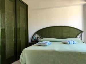 a bedroom with a bed with two pillows on it at spettacolare suite Tragara Capri in Capri