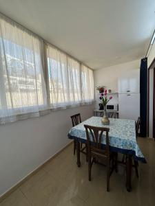 a dining room with a table and chairs and a refrigerator at Le Trottole Apartment in Palermo