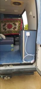an open back door of a van with a bed and a mattress at Casa movil in Santa Gertrudis de Fruitera