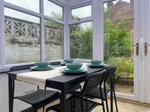 a dining room with a table and chairs and a window at 3 bed house Hyde near Manchester in Hyde