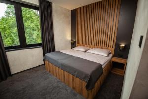 Ένα ή περισσότερα κρεβάτια σε δωμάτιο στο Hotel Kras