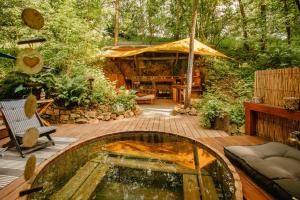 a patio with a pool in front of a house at Yurt in the Wood 