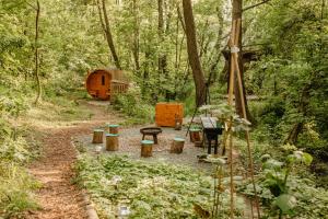 a garden with a table and benches in the woods at Yurt in the Wood 