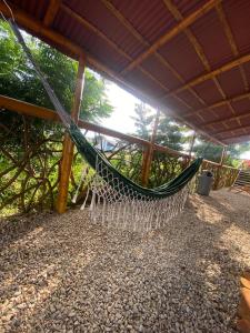 a hammock hanging from a roof on a patio at Casa - El Arrecife in Engabao