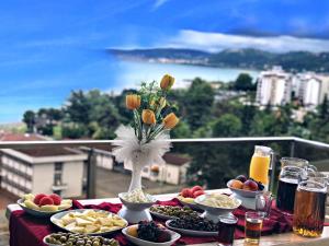 a table with plates of food on top of a balcony at FENDE DOLG SUITE APARTMENTS in Cimenli
