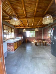 a large room with a brick wall and wooden ceilings at Casa - El Arrecife in Engabao