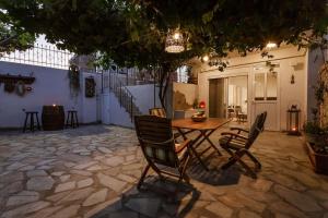 a patio with a table and chairs on a stone floor at Serenity Studio for couples in Rhodes Town