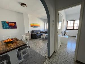 a living room with a table and a couch at Casa Evan El charco in Arrecife