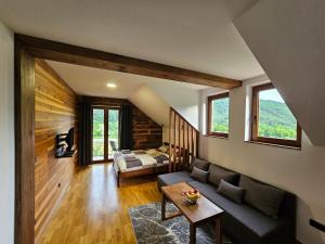 a living room with a couch and a table at Apartment 112 in Mokra Gora
