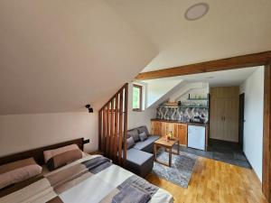 a bedroom with a bed and a living room at Apartment 112 in Mokra Gora
