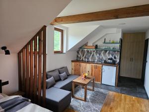 a living room with a couch and a kitchen at Apartment 112 in Mokra Gora