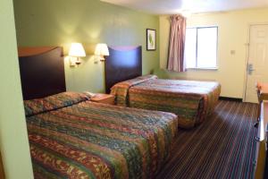 Ένα ή περισσότερα κρεβάτια σε δωμάτιο στο Executive Inn Odessa