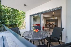 a patio with a table and chairs on a balcony at Residence Bella Vista in Bibinje