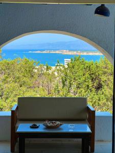 a couch in a room with a view of the ocean at pirgaki seaside house in Naxos Chora