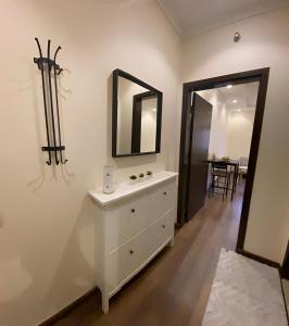 a bathroom with a white dresser and a mirror at 2 Bedrooms Apartment in Makkah in Makkah