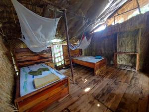 an attic room with a bed and a table at Mountain Bikes House in Moshi