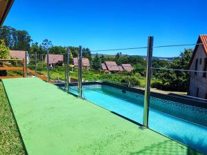 a swimming pool with a fence around it at Casa Baixo O Castelo in Puente Caldelas