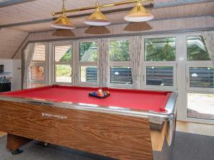 a pool table in a room with windows at 14 person holiday home in R m in Kongsmark