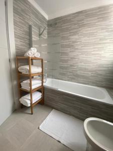 a bathroom with a tub and a sink and a toilet at Beach Apartment La Cala de Mijas in La Cala de Mijas